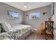 Cozy bedroom with lots of natural light and a chair perfect for a reading nook at 4713 S Robb St, Littleton, CO 80127