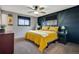Stylish bedroom features a unique accent wall and comfortable furnishings with natural light at 4713 S Robb St, Littleton, CO 80127
