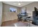 Bedroom featuring light gray walls, wood trim, ceiling fan, and a scenic outdoor view from the window at 4713 S Robb St, Littleton, CO 80127