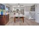 Bright kitchen features white cabinets, stainless steel appliances, a breakfast bar, and wood floors at 4713 S Robb St, Littleton, CO 80127