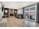 Inviting living room featuring a brick fireplace, a sliding glass door, and stylish decor at 4713 S Robb St, Littleton, CO 80127