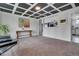 Relaxing living room features carpet, a coffered ceiling, and an open pass-through at 4713 S Robb St, Littleton, CO 80127