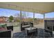 Relaxing covered patio with comfortable seating, string lights, and a scenic view at 4713 S Robb St, Littleton, CO 80127