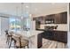 Modern kitchen features stainless steel appliances and an island with seating at 5921 Wheatberry Dr, Brighton, CO 80601