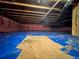 Unfinished basement with exposed ceiling, insulation, and bright blue flooring, ready for your personal touch at 15523 E 117Th Ave, Commerce City, CO 80022
