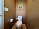 Powder room featuring a standard white toilet and tan-colored walls at 15523 E 117Th Ave, Commerce City, CO 80022