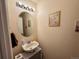 Small bathroom with decorative mirror, sink, lighting fixture, and neutral colored walls at 15523 E 117Th Ave, Commerce City, CO 80022