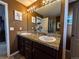 Bathroom featuring double sinks with granite countertop and vanity lighting at 15523 E 117Th Ave, Commerce City, CO 80022