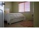 Bedroom with neutral-toned walls, white wooden bed frame, and a full vanity at 15523 E 117Th Ave, Commerce City, CO 80022