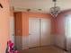Bedroom featuring an ornamental chandelier, sliding closet, and neutral colored walls at 15523 E 117Th Ave, Commerce City, CO 80022