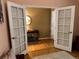 A grand entryway with hardwood floors, a mirror, and open French doors to a side room at 15523 E 117Th Ave, Commerce City, CO 80022
