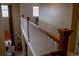 Hallway with wood railing overlooking sitting area with view of the outdoors at 15523 E 117Th Ave, Commerce City, CO 80022