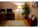 Inviting home office featuring a desk, comfortable chair, stylish lamp, and a cozy red sofa at 15523 E 117Th Ave, Commerce City, CO 80022