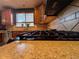 Close-up of kitchen features a gas range and granite countertops at 15523 E 117Th Ave, Commerce City, CO 80022