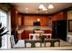Bright and airy kitchen with wooden cabinets, stainless steel appliances, and stylish lighting fixtures at 15523 E 117Th Ave, Commerce City, CO 80022