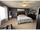 Cozy main bedroom with gray walls, king bed, and a mirrored dresser at 15523 E 117Th Ave, Commerce City, CO 80022