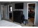 Main bedroom featuring a dresser with mounted TV, a walk-in closet, and an ensuite bathroom at 15523 E 117Th Ave, Commerce City, CO 80022