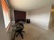 Spacious office with a glass desk, accent chair, and burgundy accent wall at 15523 E 117Th Ave, Commerce City, CO 80022