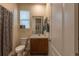 Well-maintained bathroom with vanity, toilet, shower with curtain and neutral decor at 22820 E Chenango Ave, Aurora, CO 80015