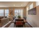 Dining area with a wooden table, six chairs, and natural light from the sliding glass door at 22820 E Chenango Ave, Aurora, CO 80015