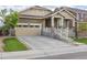 Inviting home with a spacious driveway leading to a two-car garage, complemented by green landscaping at 22820 E Chenango Ave, Aurora, CO 80015