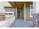 Welcoming front porch with stone pillars and railings, offering a cozy entrance to the home at 22820 E Chenango Ave, Aurora, CO 80015