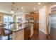 Open concept kitchen with granite counters, island, stainless steel appliances and wood cabinetry at 22820 E Chenango Ave, Aurora, CO 80015