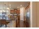 Well-equipped kitchen featuring granite countertops, wood cabinets, stainless steel appliances, and hardwood flooring at 22820 E Chenango Ave, Aurora, CO 80015