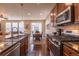 Modern open floor plan kitchen with stainless appliances, granite counters, hardwood flooring, and eat in dining area at 22820 E Chenango Ave, Aurora, CO 80015