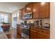Updated kitchen with modern stainless appliances, granite counters, hardwood floors, and eat in dining area at 22820 E Chenango Ave, Aurora, CO 80015