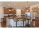Open kitchen with an island with granite countertop, bar seating and pendant lighting at 22820 E Chenango Ave, Aurora, CO 80015