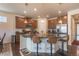 Open kitchen with an island with granite countertop, bar seating and pendant lighting at 22820 E Chenango Ave, Aurora, CO 80015