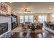 Open living room featuring a fireplace, plush seating, and large windows for natural light at 22820 E Chenango Ave, Aurora, CO 80015