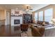 Open-concept living room with a fireplace, built-in shelving, and comfortable leather furniture at 22820 E Chenango Ave, Aurora, CO 80015