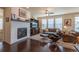 Comfortable living room with a fireplace, hardwood floors, and large windows for natural light at 22820 E Chenango Ave, Aurora, CO 80015