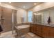 Luxurious main bathroom with a soaking tub, a separate shower, and dual vanities at 22820 E Chenango Ave, Aurora, CO 80015