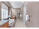 Bright primary bathroom featuring soaking tub, marble countertops, and glass enclosed shower at 3143 Elmira St, Denver, CO 80238