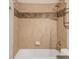 Bathroom featuring tile shower with built in shelves and showerhead at 3143 Elmira St, Denver, CO 80238