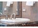 Close up of sink and vanity with marble countertop and traditional faucet fixtures at 3143 Elmira St, Denver, CO 80238