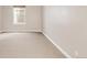Neutral colored bedroom featuring a window and carpet flooring at 3143 Elmira St, Denver, CO 80238
