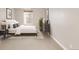 Cozy bedroom featuring a comfortable bed, neutral wall color, window and carpet flooring at 3143 Elmira St, Denver, CO 80238