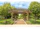 Inviting community pergola with benches, lush landscaping, and shaded walkway for relaxation at 3143 Elmira St, Denver, CO 80238