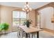 Beautifully staged dining area featuring elegant lighting, large windows, and inviting decor elements at 3143 Elmira St, Denver, CO 80238