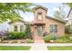 Charming stone home featuring a lovely tiled roof, lush landscaping, and inviting front entrance at 3143 Elmira St, Denver, CO 80238