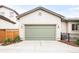 Attached garage with green doors and lighting at 3143 Elmira St, Denver, CO 80238