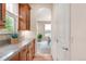 A charming kitchen adjacent to the dining room with ample natural light and hardwood floors at 3143 Elmira St, Denver, CO 80238