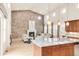 An open-concept living space with a striking stone wall, fireplace, and hardwood floors at 3143 Elmira St, Denver, CO 80238