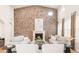 Inviting living area boasting a grand stone fireplace, neutral furniture, and ample natural light at 3143 Elmira St, Denver, CO 80238