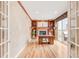 Home office with custom built-ins, fireplace, and sliding glass doors to patio at 3143 Elmira St, Denver, CO 80238