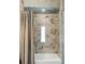 Marble tiled shower with glass door and shower curtain at 3143 Elmira St, Denver, CO 80238
